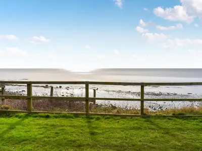 a fence with a view of the beach at Ocean View in Lancaster
