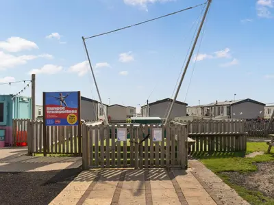 a wooden fence with a sign in front of houses at Ocean View in Lancaster