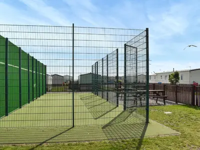 a chain link fence with a picnic table behind it at Ocean View in Lancaster