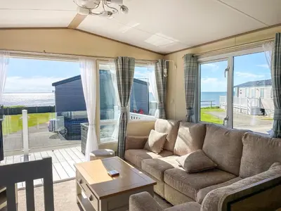 a living room with a couch and a view of the ocean at Ocean View in Lancaster