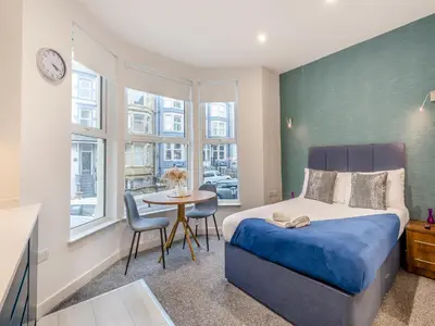a bedroom with a bed and a table with chairs at Promenade - Uk48690 in Lancaster