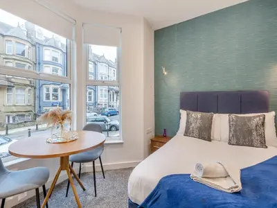 a bedroom with a bed and a table and a window at Promenade - Uk48690 in Lancaster