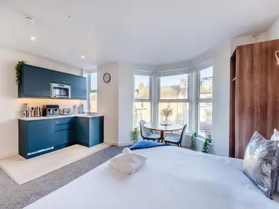 a bedroom with a large bed and a table at Pier View - Uk48691 in Lancaster