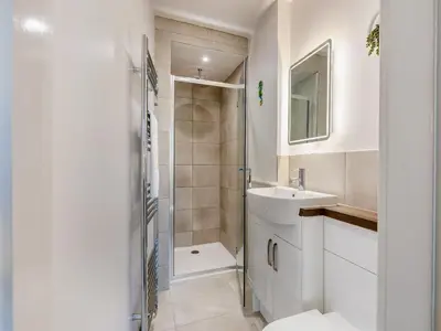a white bathroom with a sink and a shower at Sand Dune - Uk48699 in Lancaster