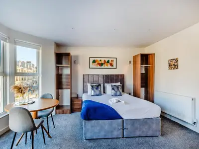 a bedroom with a bed and a table and chairs at Sand Dune - Uk48699 in Lancaster