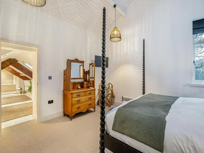 a bedroom with a swinging bed and a mirror at The B Hive At Buckstone House in Carnforth