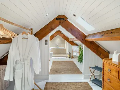 a room with white walls and a ceiling with wooden beams at The B Hive At Buckstone House in Carnforth