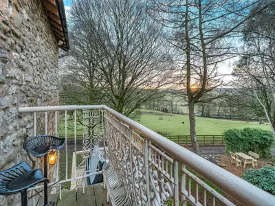 a balcony with chairs and a view of a park at The B Hive At Buckstone House in Carnforth