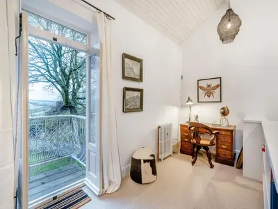 a home office with a desk and a large window at The B Hive At Buckstone House in Carnforth