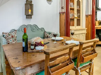 a wooden table with a bottle of wine and wine glasses at The B Hive At Buckstone House in Carnforth