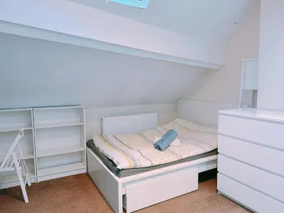 a small white room with a bed and a dresser at The Comfy Lofty Studio - R9 in Liverpool