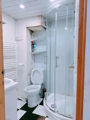 a bathroom with a toilet and a glass shower at The Comfy Lofty Studio - R9 in Liverpool
