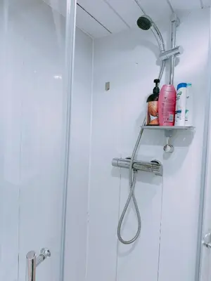 a bathroom with a shower with a shelf and a shower at The Comfy Lofty Studio - R9 in Liverpool