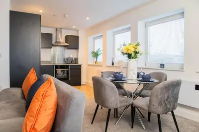 a kitchen and living room with a table and chairs at Luxury Apartment - Sleeps 5 - Rose Platinum Properties in Liverpool