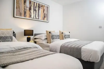 two beds in a room with white walls at Luxury Apartment - Sleeps 5 - Rose Platinum Properties in Liverpool