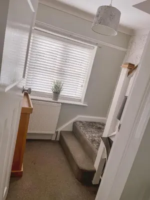 a staircase in a room with a window and a stair case at The Willows in Whalley