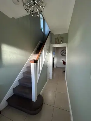 a staircase in a home with a chandelier at The Willows in Whalley