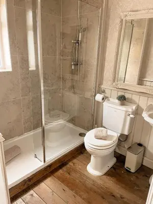 a bathroom with a shower and a toilet and a tub at The Willows in Whalley