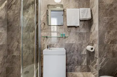 a bathroom with a shower and a toilet and a sink at Thirlmere House - Air Host & Stay - 5 Bedrooms in Liverpool