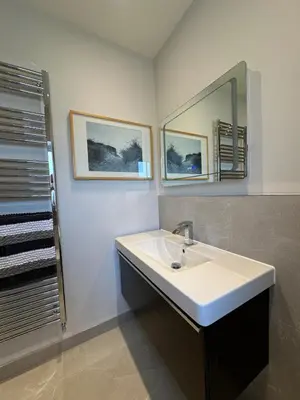 a bathroom with a sink and a mirror at Poppy Cottage, Mawdesley Village in Mawdesley