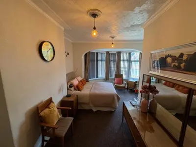 a bedroom with a bed and a living room at The Golden Sands in Blackpool