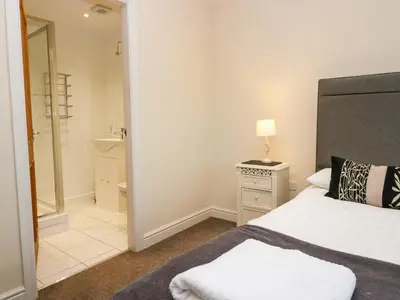 a bedroom with a bed and a bathroom at 4 Teal House in Carnforth