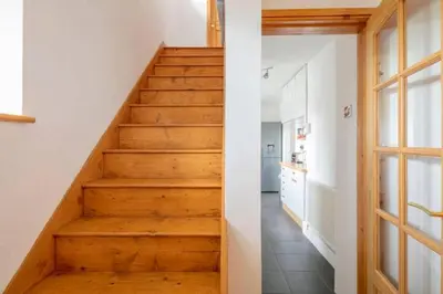 a staircase in a house with wooden floors at Bright Double Room, Smart TV, Very Close to Train Station in Egerton