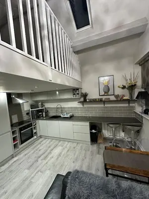 a large kitchen with stainless steel appliances and a ceiling at Luxury two bedroom Loft in Croston