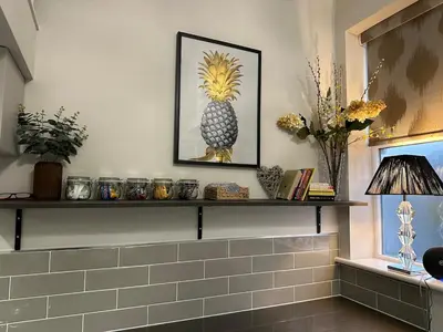 a shelf with a picture of a pineapple on it at Luxury two bedroom Loft in Croston