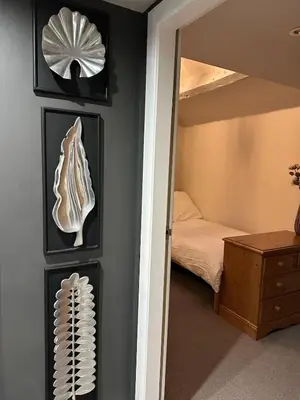 a room with a bedroom with a bed and a mirror at Luxury two bedroom Loft in Croston