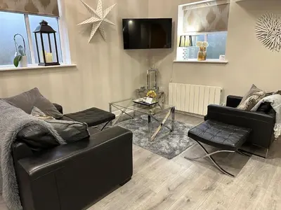 a living room with a couch and a table at Luxury two bedroom Loft in Croston