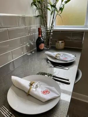 a table with a plate with a napkin and a bottle of wine at Luxury two bedroom Loft in Croston