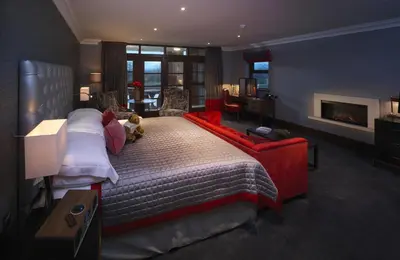 a bedroom with a bed with a teddy bear on it at Northcote in Langho