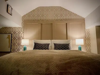 a bedroom with a large bed with two lamps at Sleeps10-Parking-Garden-HotTub-PetFriendly in Blackpool