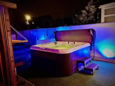 a bath tub with purple lights in a room at Sleeps10-Parking-Garden-HotTub-PetFriendly in Blackpool