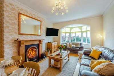 a living room with a couch and a fireplace at 3 Bed in Lytham St. Annes oc-m30622 in Saint Annes on the Sea