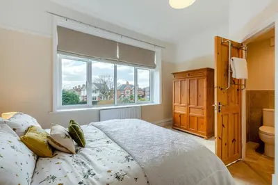 a bedroom with a bed and a window and a toilet at 3 Bed in Lytham St. Annes oc-m30622 in Saint Annes on the Sea