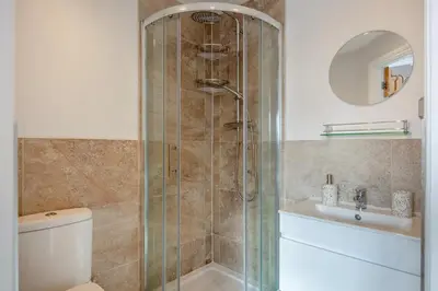a bathroom with a shower and a toilet and a sink at 3 Bed in Lytham St. Annes oc-m30622 in Saint Annes on the Sea
