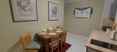 a dining room table and chairs with candles on it at The Enigma - 2 Master bedrooms sleeps 6 in Blackpool