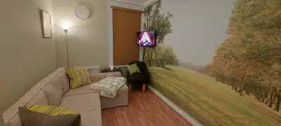 a living room with a couch and a painting on the wall at The Enigma - 2 Master bedrooms sleeps 6 in Blackpool
