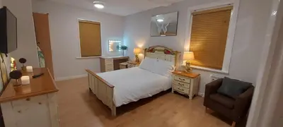 a small bedroom with a bed and a chair at The Enigma - 2 Master bedrooms sleeps 6 in Blackpool