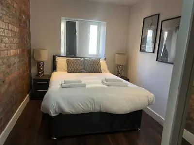 a bedroom with a bed with two pillows on it at Castle Street 2 Bedroomed Next to The IVY in Liverpool