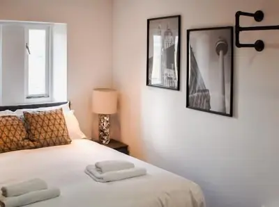 a bedroom with a bed with two towels on it at Castle Street 2 Bedroomed Next to The IVY in Liverpool