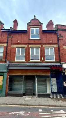 a red brick building on a city street at The Loft At One Luxury Penthouse in Wigan