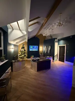 a large living room with a christmas tree in the middle at The Loft At One Luxury Penthouse in Wigan