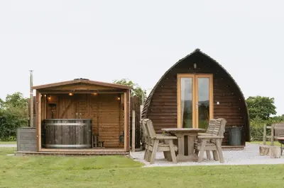 a cabin with a table and chairs in front of it at Ribble Valley by Wigwam Holidays in Langho