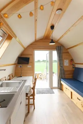 a kitchen and dining room in a tiny house at Ribble Valley by Wigwam Holidays in Langho