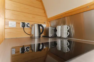 a kitchen with two coffee pots and pans on a counter at Ribble Valley by Wigwam Holidays in Langho