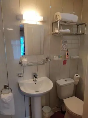 a small bathroom with a sink and a toilet at The Norwood Hotel in Blackpool