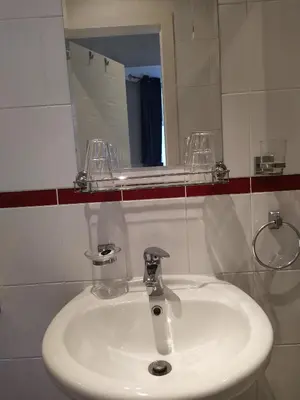 a bathroom with a white sink and a mirror at The Norwood Hotel in Blackpool